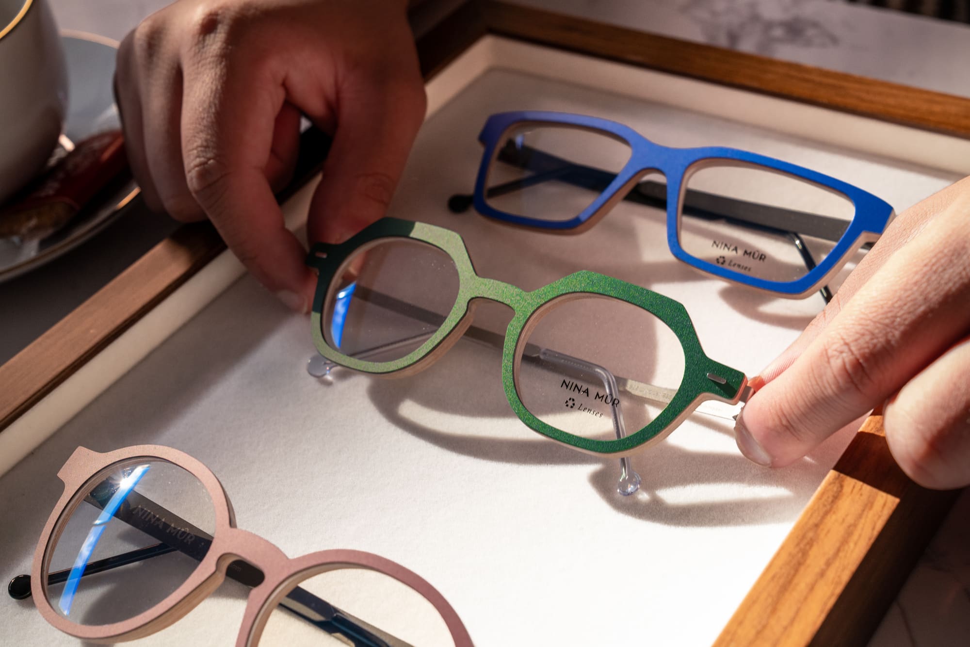 Choosing between designer frames during a styling appointment