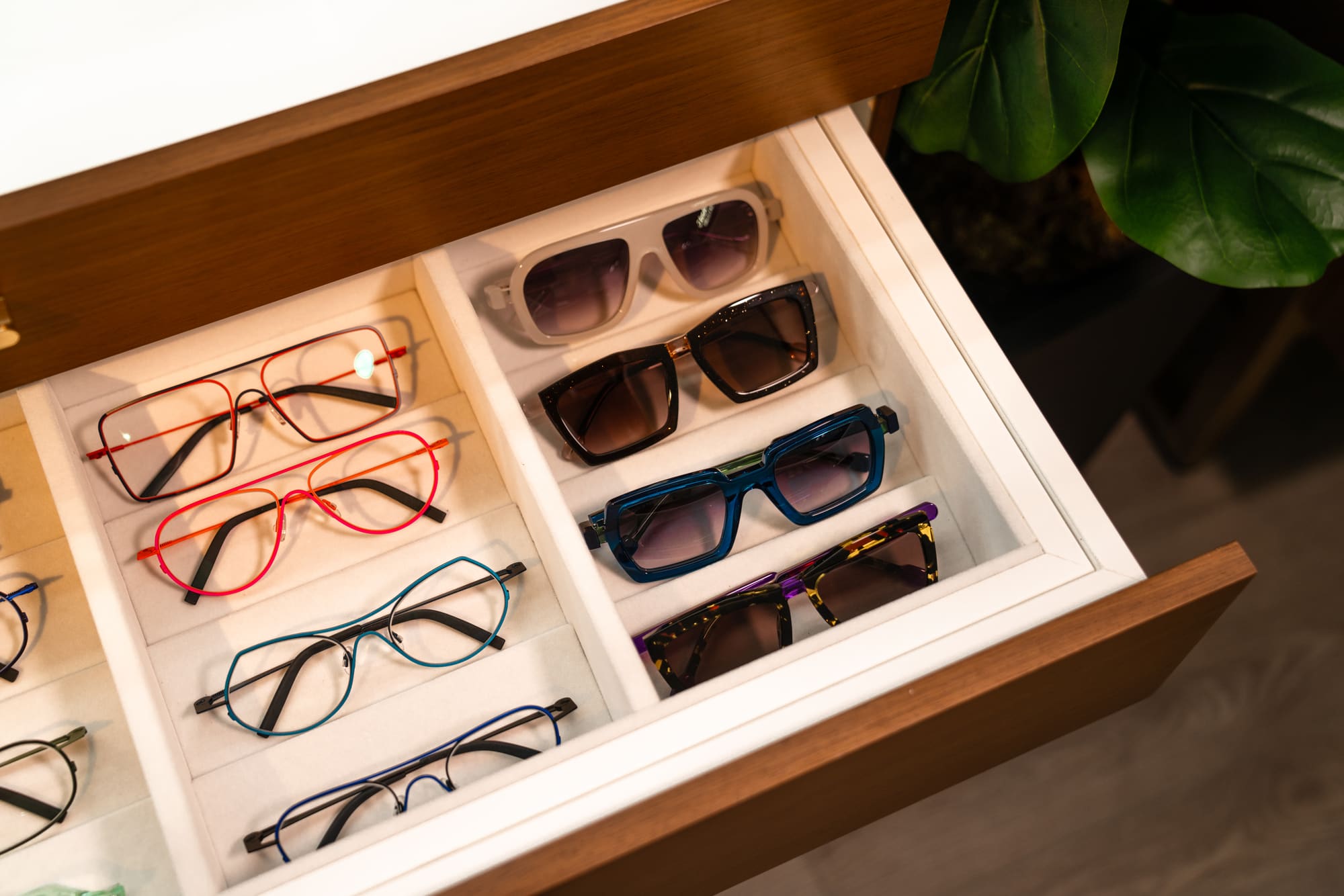 Sunglasses and coloured frames in a display drawer