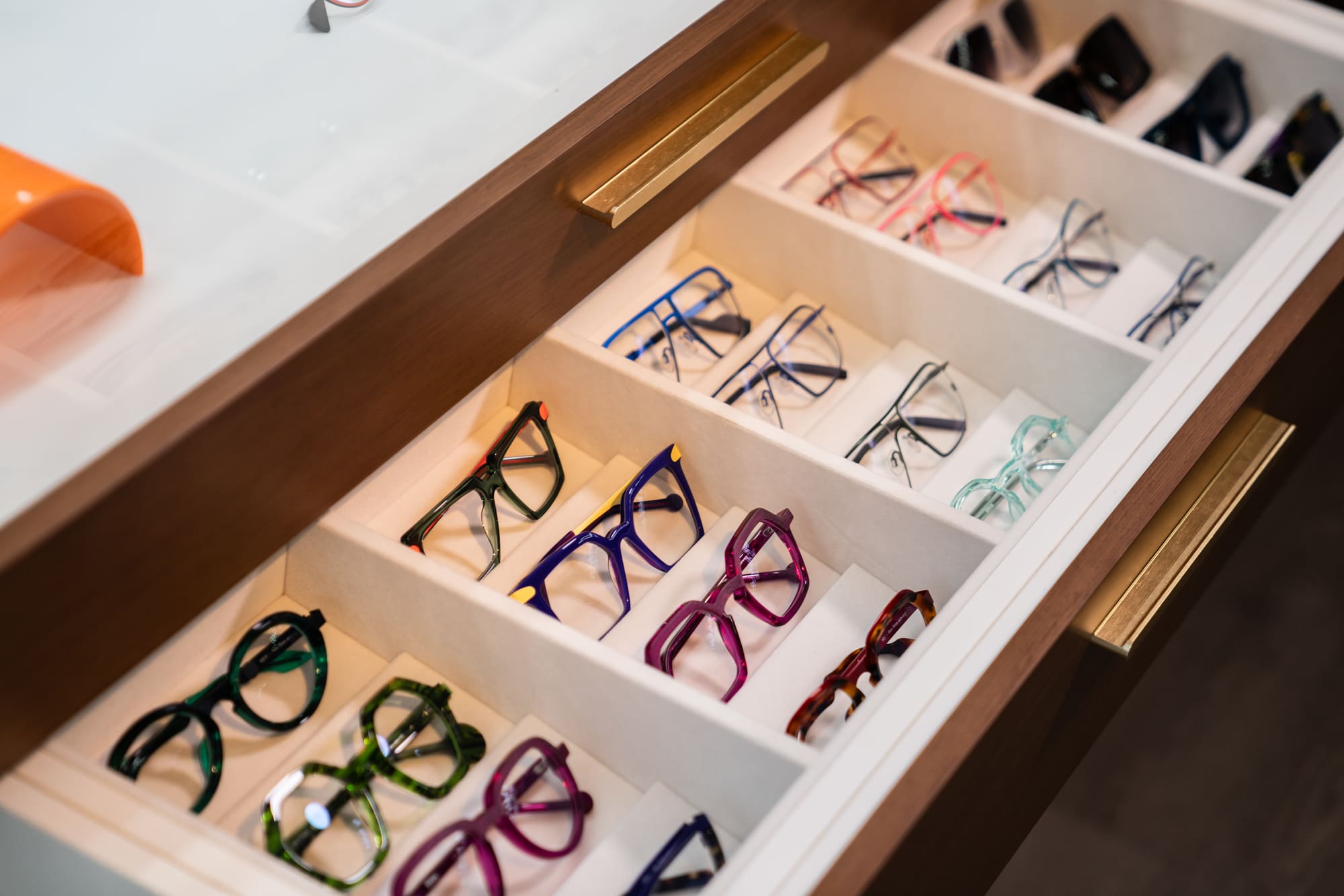 Sunglasses and colourful frames in a display drawer