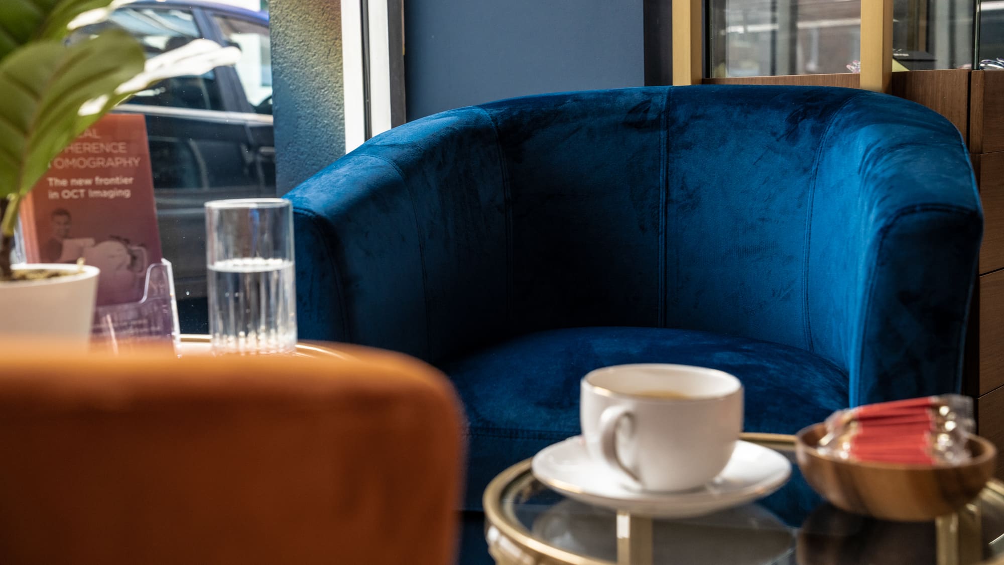 Blue velvet armchair with a coffee in the waiting area